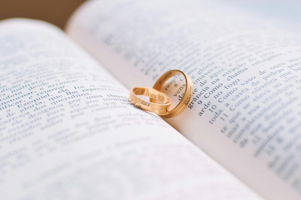pexels-photo-56926-56926-1 Close-up of wedding rings resting on the pages of an open book, symbolizing love and commitment.